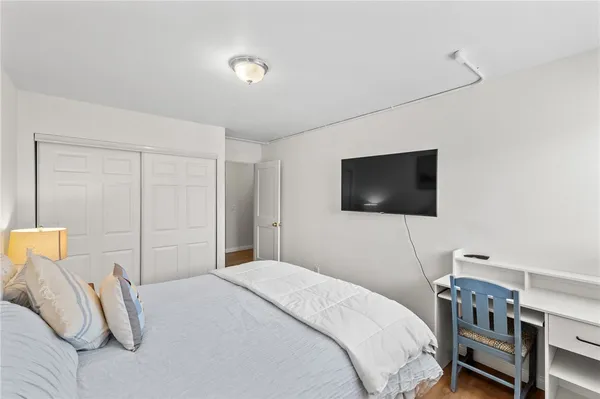 a bedroom with a bed and a flat screen tv