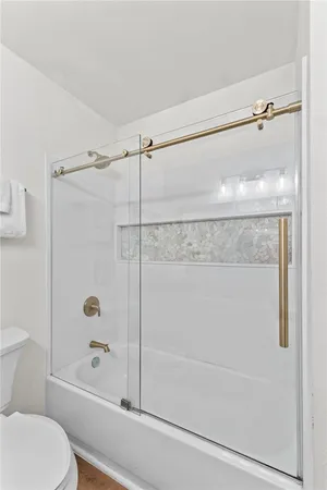 a bathroom with a shower and a toilet