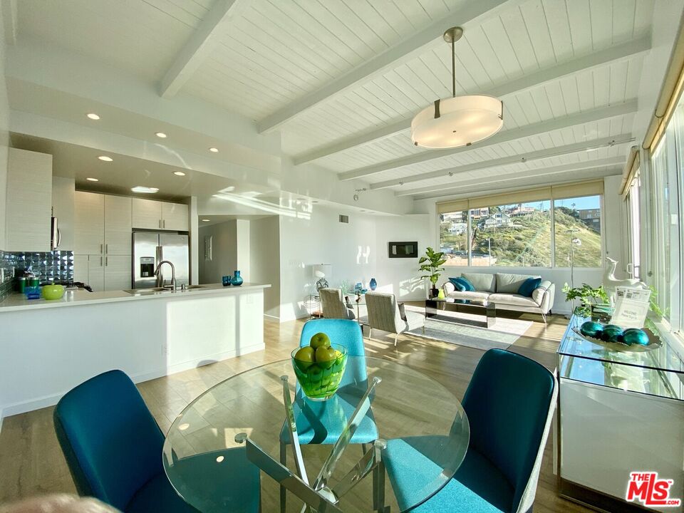 6824 Esplanade, Unit PH Playa del Rey, CA 90293 - Photo 4 of 20 a large kitchen with a table chairs and a dining table