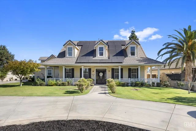 a front view of a house with garden and plants