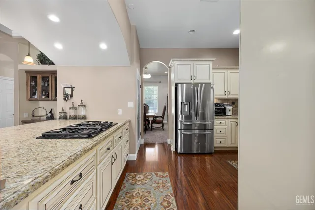 a kitchen with stainless steel appliances granite countertop a stove sink and cabinets