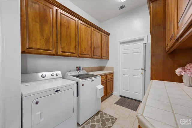 a front view of a house with a garden and trees