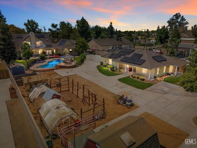 a view of swimming pool with outdoor seating and city in the background