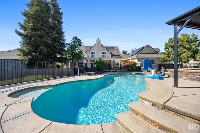 a view of a kitchen with a sink and a refrigerator