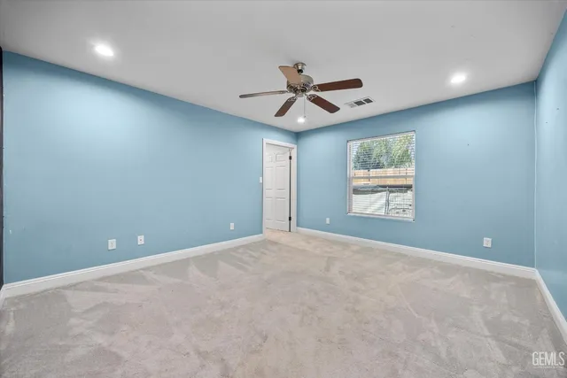 a view of a street with wooden fence