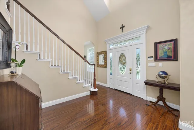 a view of entryway with wooden floor and stairs