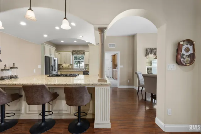 a view of a dining room with furniture large windows and wooden floor