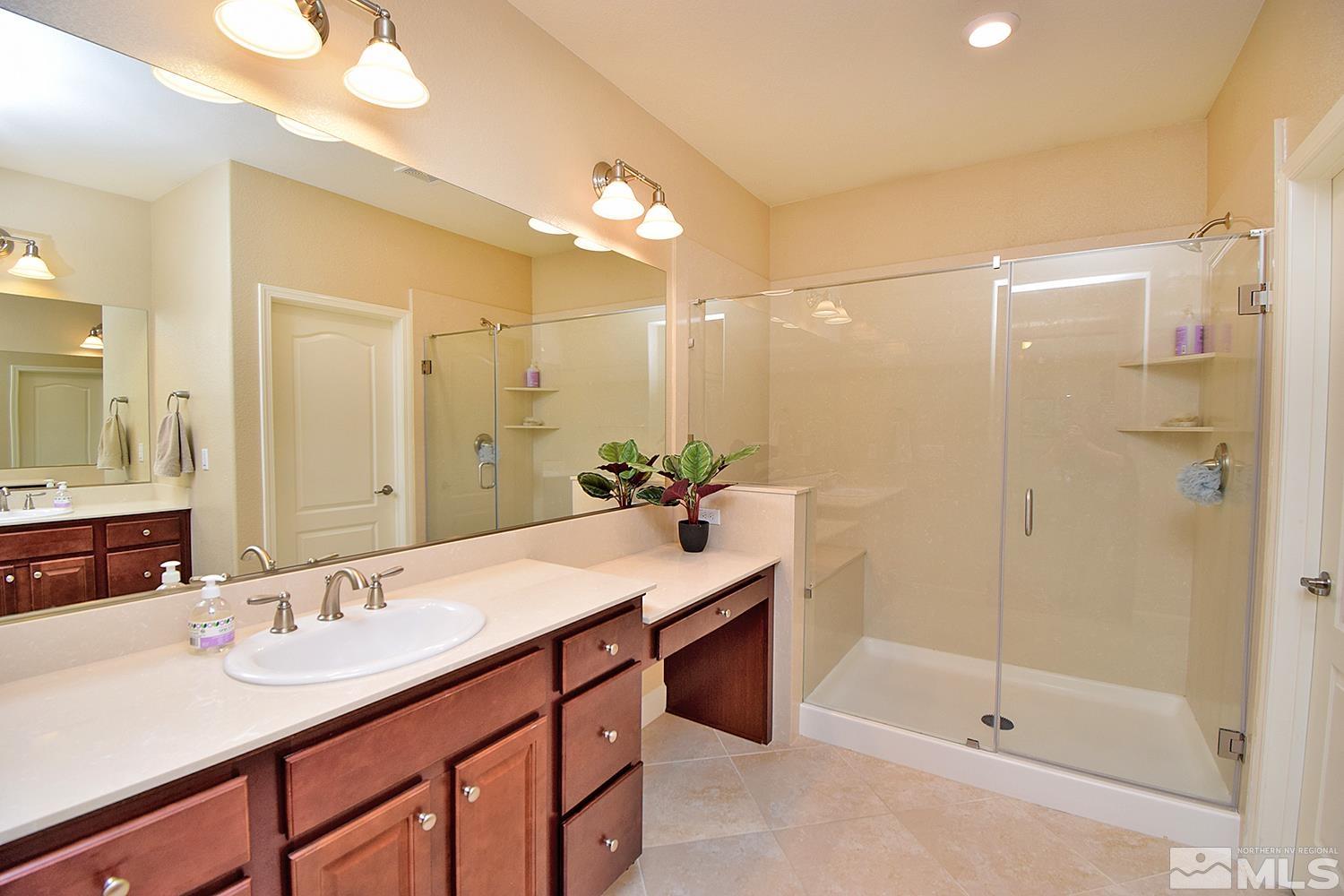 9729 Pachuca Drive Reno, NV 89521 - Photo 20 of 40 a bathroom with a sink double vanity and a shower