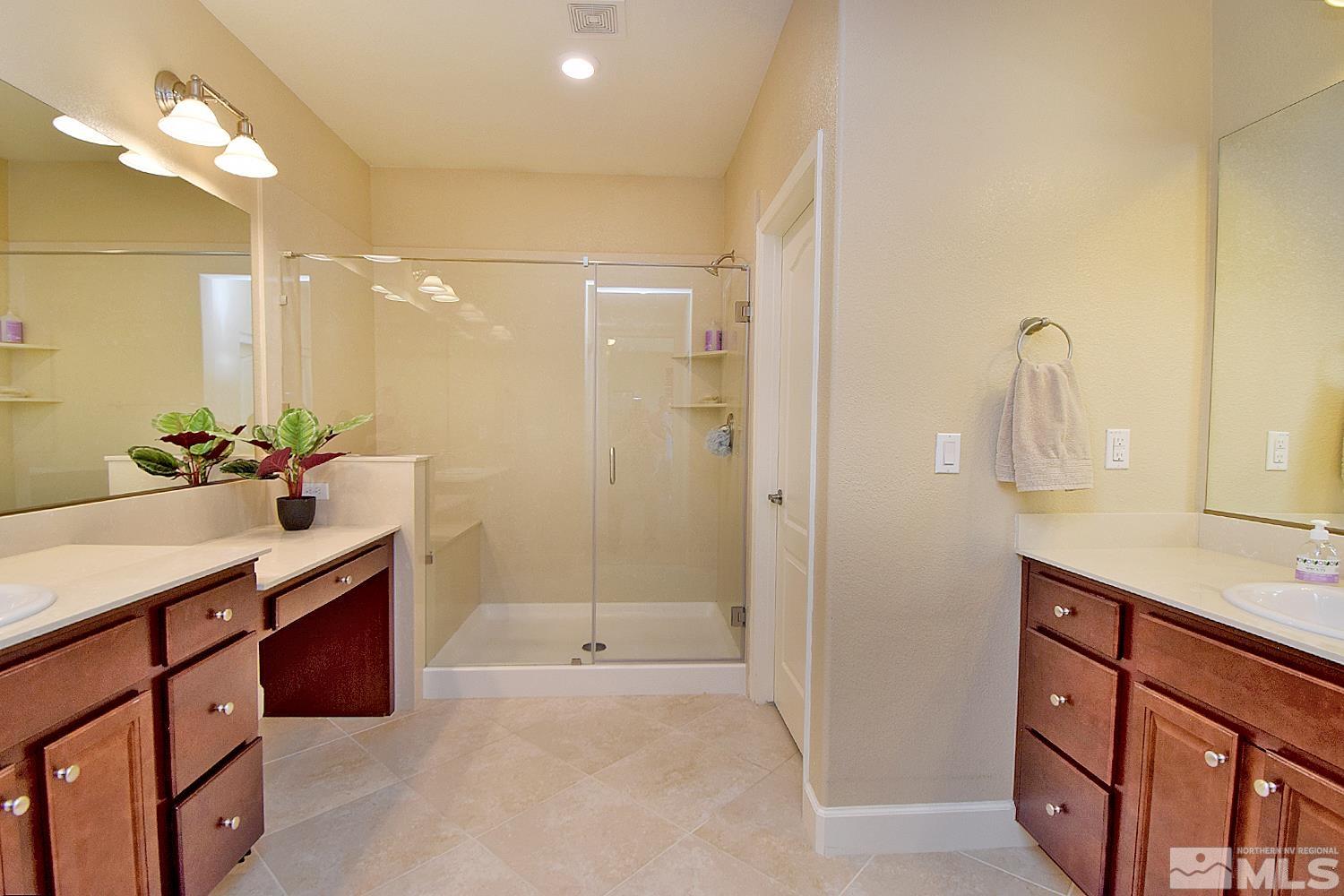 9729 Pachuca Drive Reno, NV 89521 - Photo 22 of 40 a bathroom with a sink double vanity and a mirror
