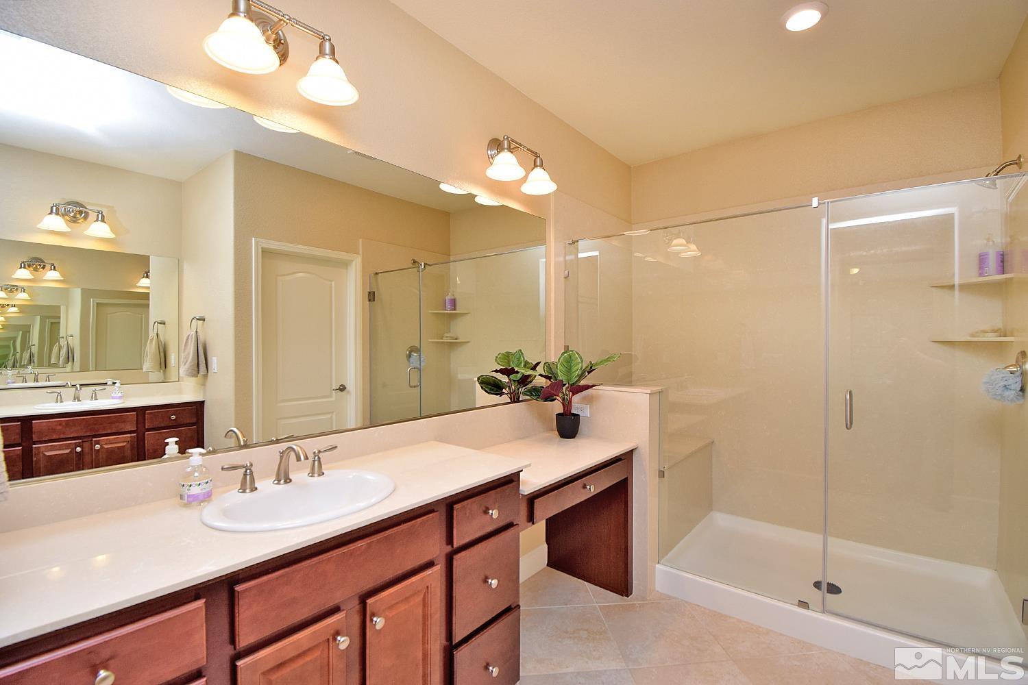 9729 Pachuca Drive Reno, NV 89521 - Photo 24 of 40 a bathroom with a sink double vanity and shower