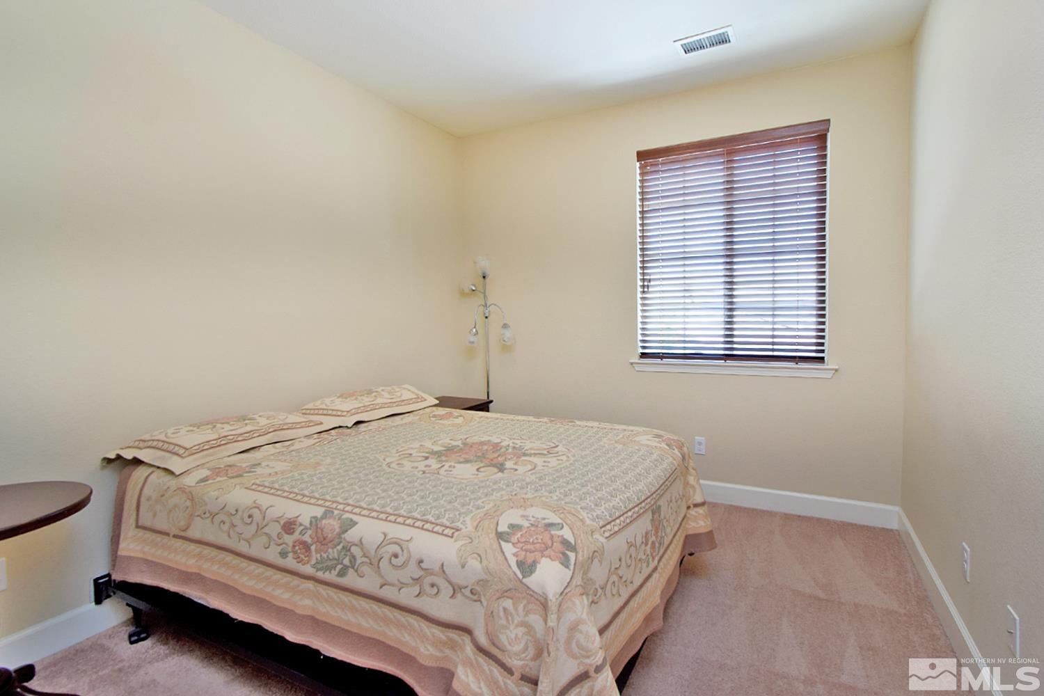 9729 Pachuca Drive Reno, NV 89521 - Photo 27 of 40 a bedroom with a bed and a window