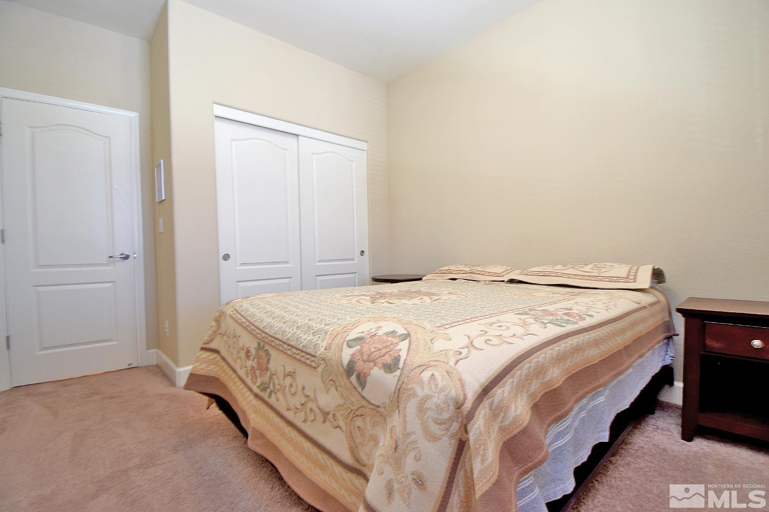 9729 Pachuca Drive Reno, NV 89521 - Photo 28 of 40 a spacious bedroom with a bed and a window