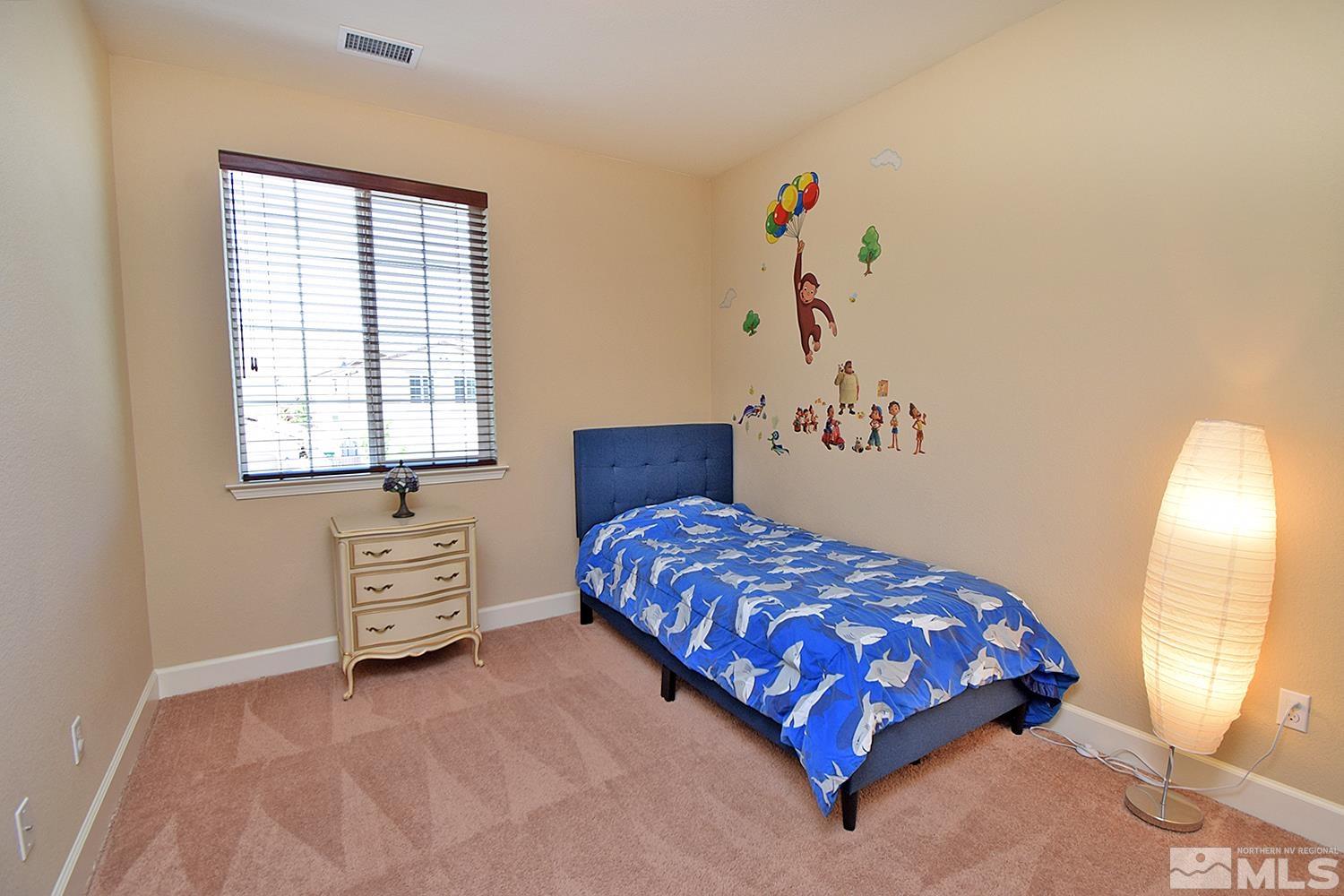 9729 Pachuca Drive Reno, NV 89521 - Photo 29 of 40 a bedroom with a bed and a window