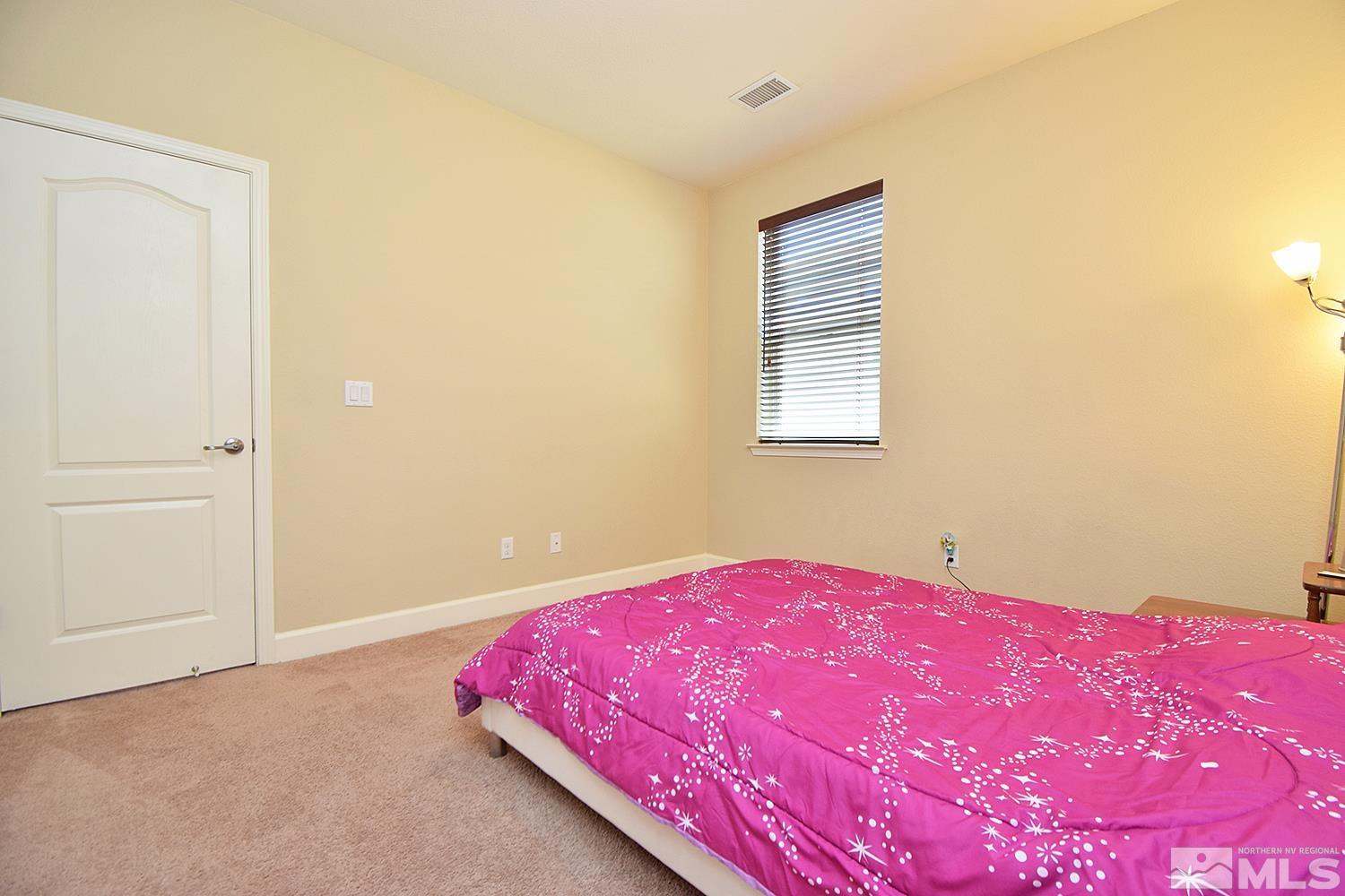9729 Pachuca Drive Reno, NV 89521 - Photo 31 of 40 a bedroom with a bed and a window