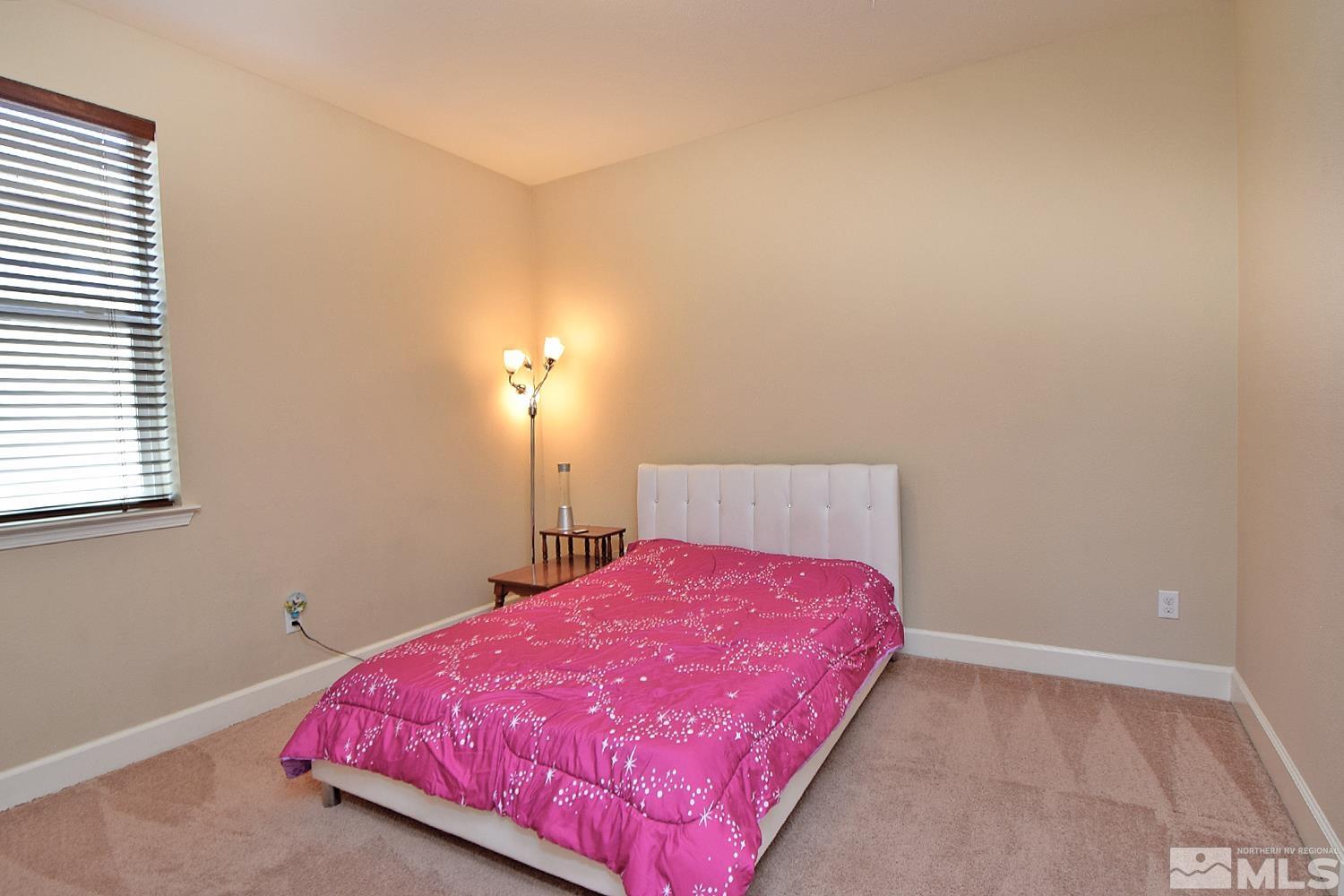 9729 Pachuca Drive Reno, NV 89521 - Photo 32 of 40 a bedroom with a bed and a window