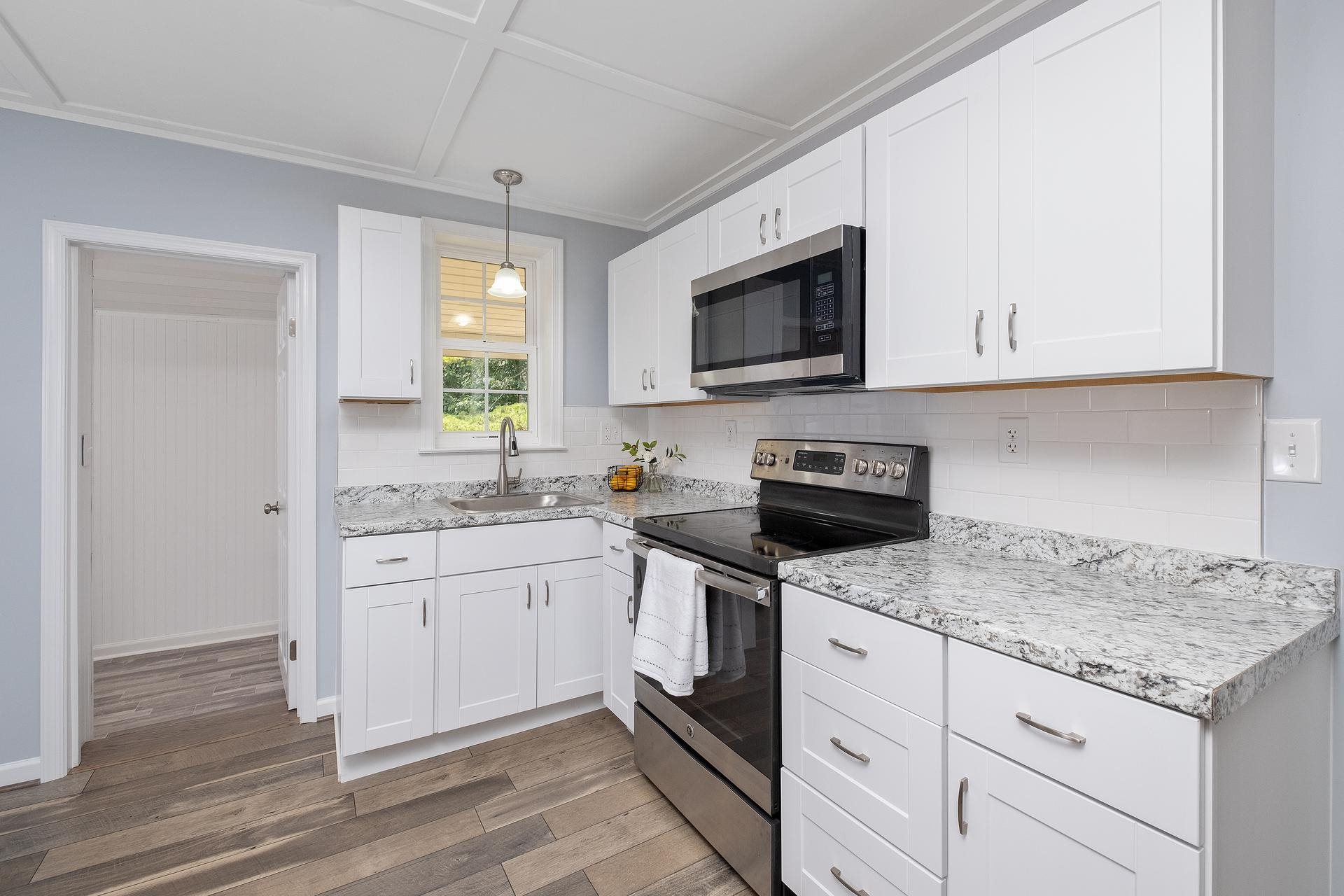 2853 Middlebrook Road Staunton, VA 24401 - Photo 12 of 29 a kitchen with granite countertop white cabinets stainless steel appliances and a sink