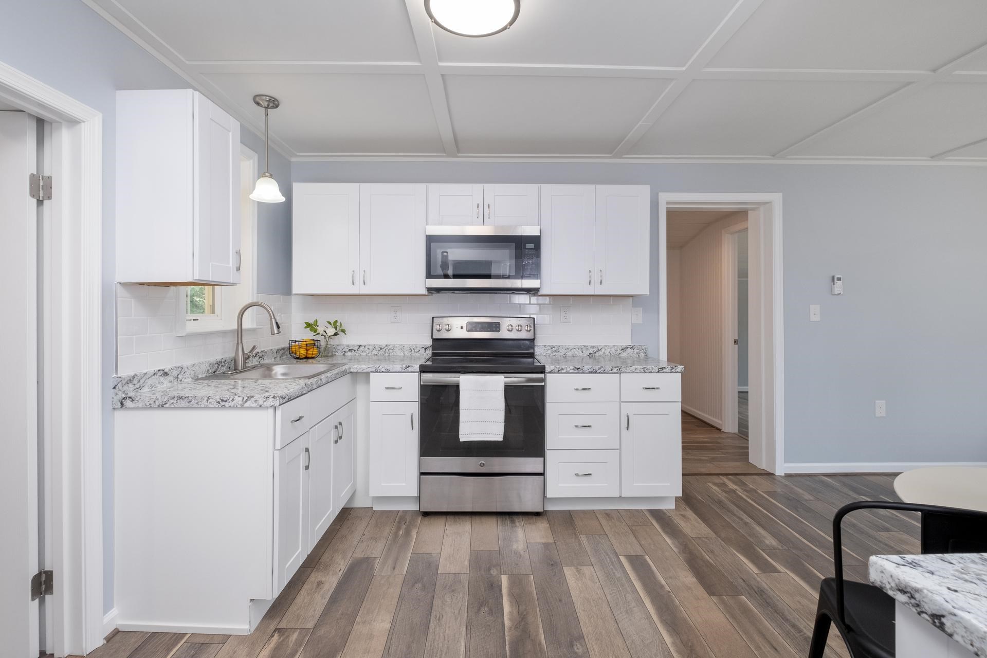 2853 Middlebrook Road Staunton, VA 24401 - Photo 15 of 29 a kitchen with granite countertop a stove top oven a sink dishwasher and a refrigerator with wooden floor