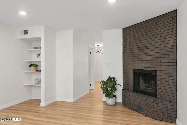 a view of an empty room and wooden floor