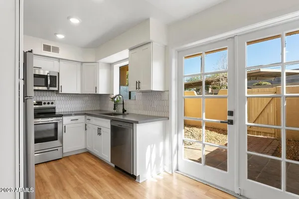 a kitchen with stainless steel appliances granite countertop a stove and a sink