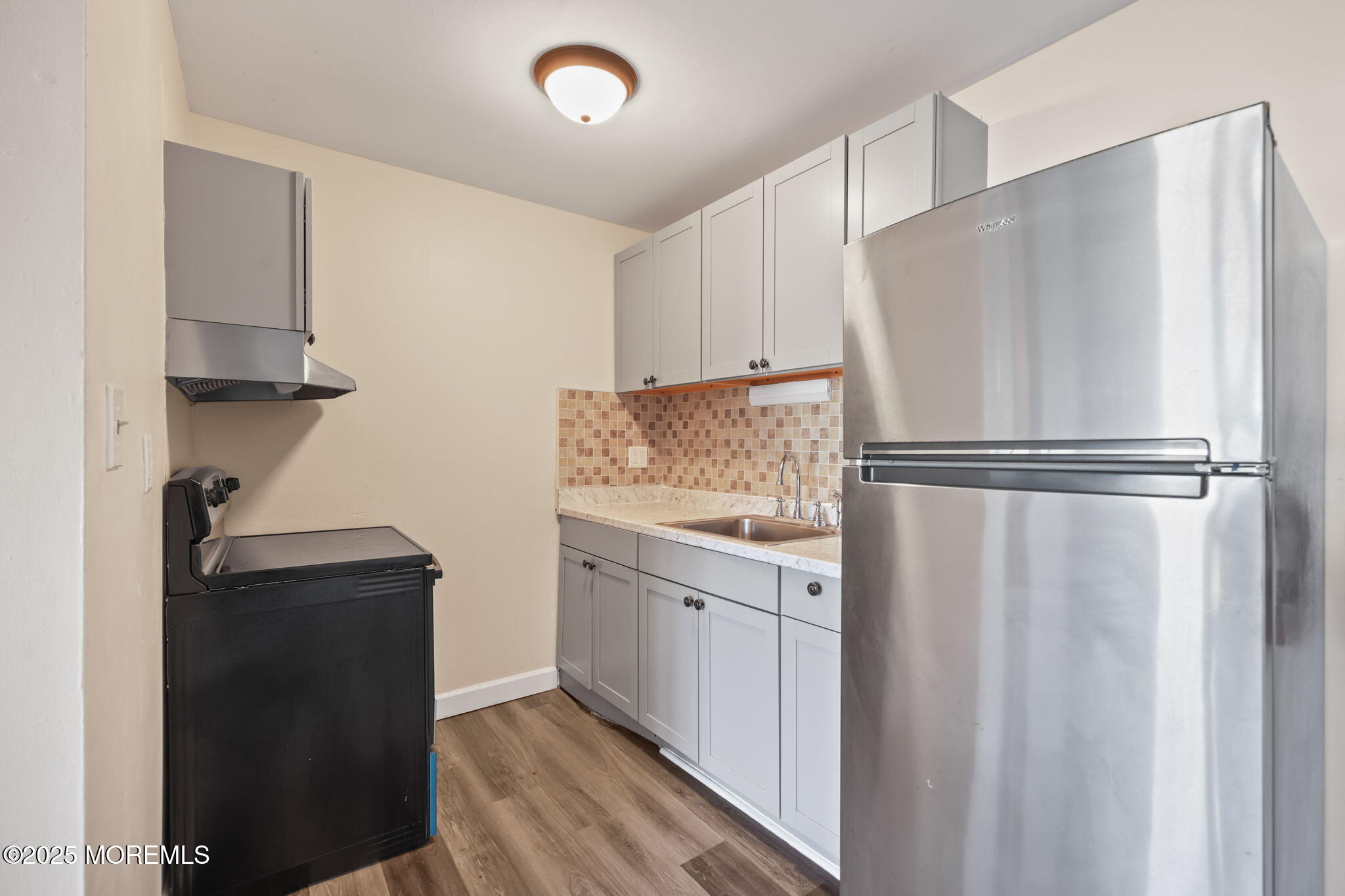 175 Buckelew Avenue, Unit BLDG 4 10 Jamesburg, NJ 08831 - Photo 11 of 31 a kitchen with a refrigerator and a sink