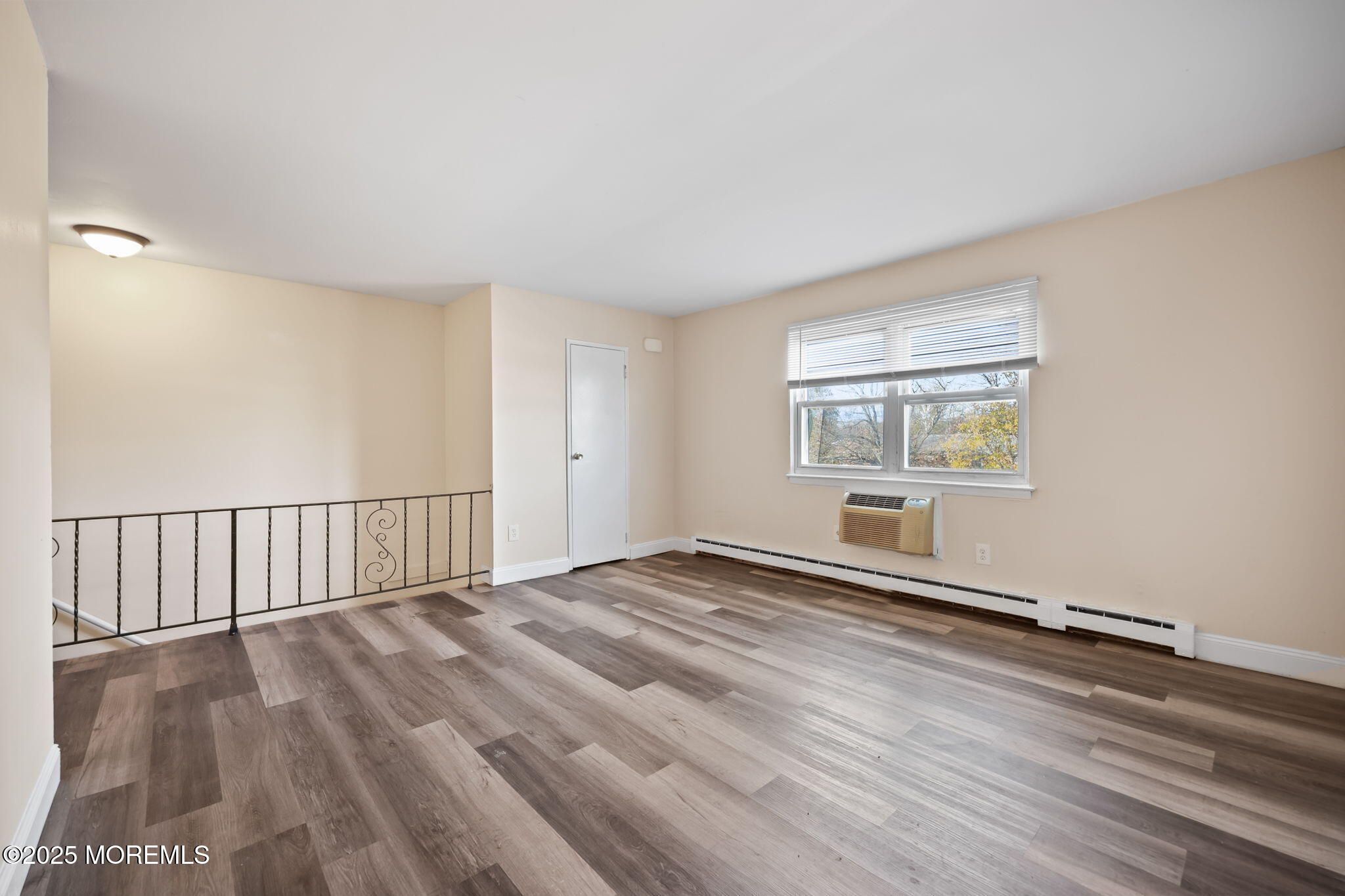175 Buckelew Avenue, Unit BLDG 4 10 Jamesburg, NJ 08831 - Photo 20 of 31 a view of an empty room with wooden floor and a window