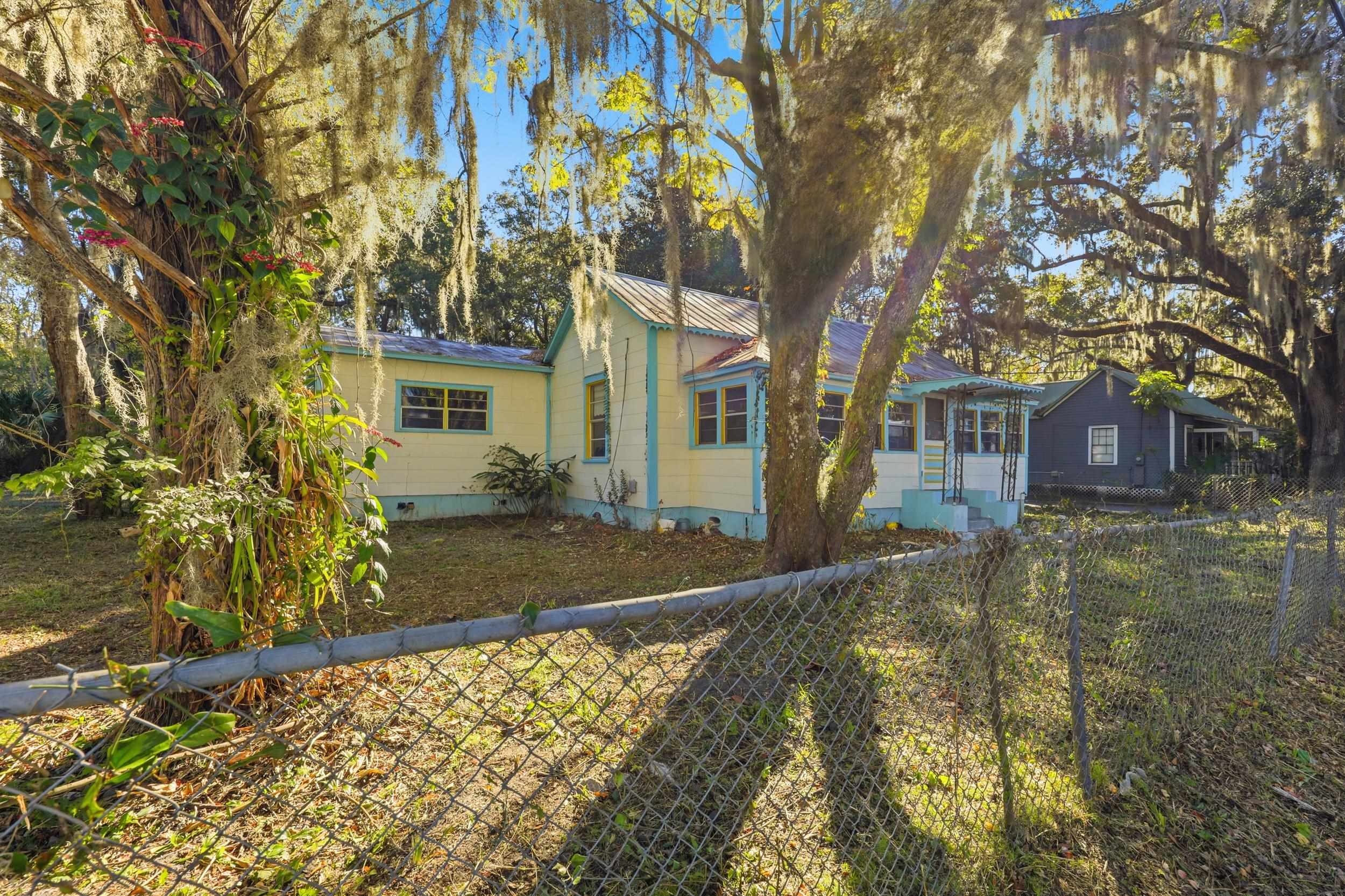 9 Masters Drive St. Augustine, FL 32084 - Photo 28 of 39 a view of a yard in front of a brick house with large tree