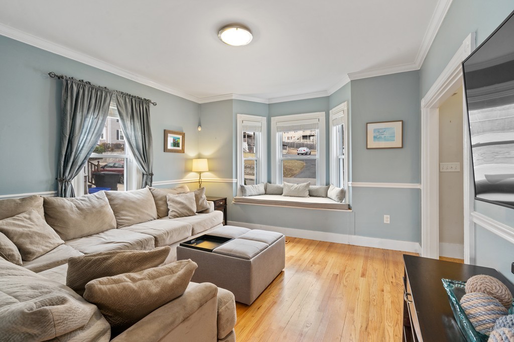 6 Porter Street, Unit 6 Woburn, MA 01801 - Photo 1 of 20 a living room with furniture and a large window