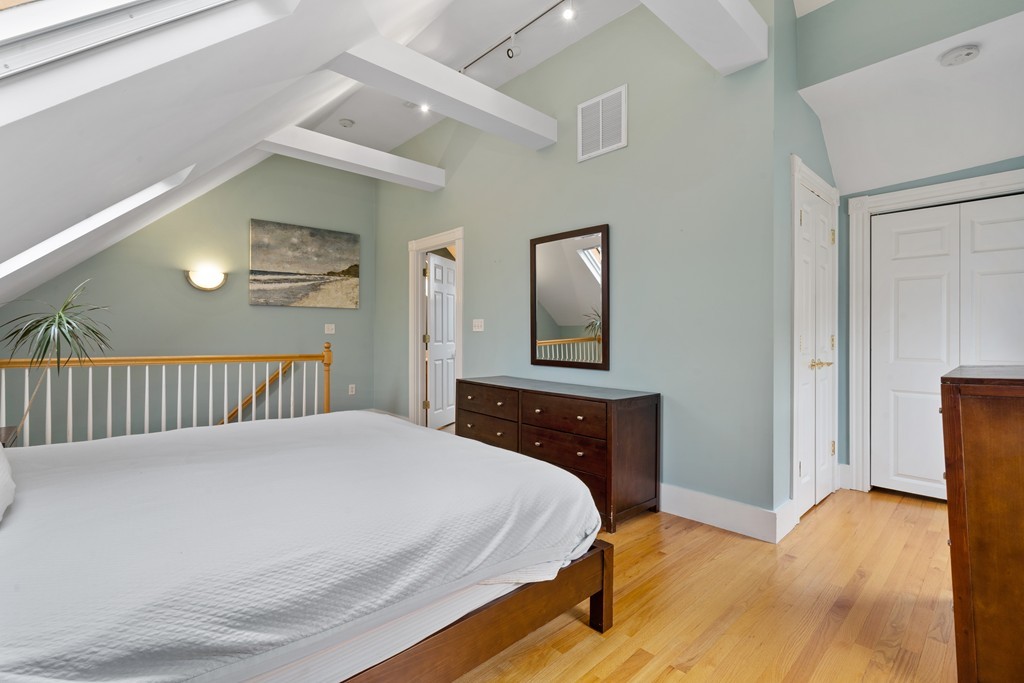 6 Porter Street, Unit 6 Woburn, MA 01801 - Photo 15 of 20 a bedroom with a bed and a painting on the wall