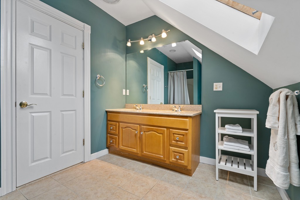 6 Porter Street, Unit 6 Woburn, MA 01801 - Photo 16 of 20 a bathroom with a sink a vanity and a large mirror