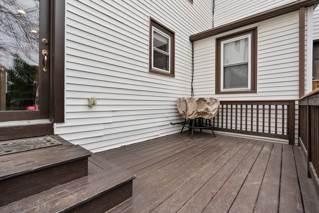 6 Porter Street, Unit 6 Woburn, MA 01801 - Photo 17 of 20 a view of a wooden deck with table and chairs with wooden floor and fence