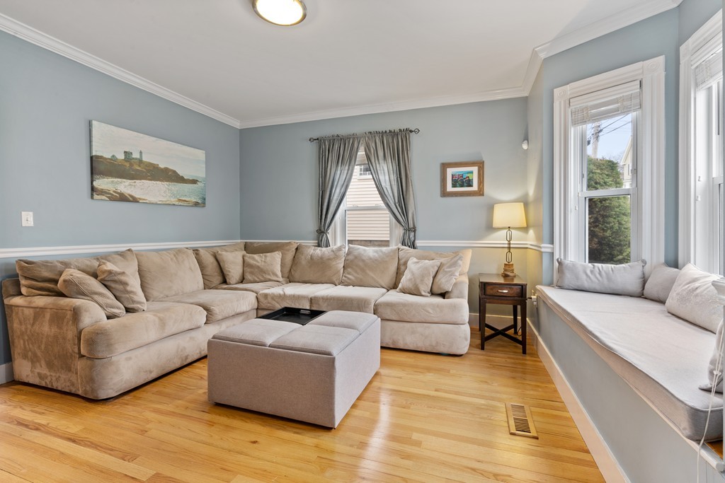 6 Porter Street, Unit 6 Woburn, MA 01801 - Photo 2 of 20 a living room with furniture and a wooden floor