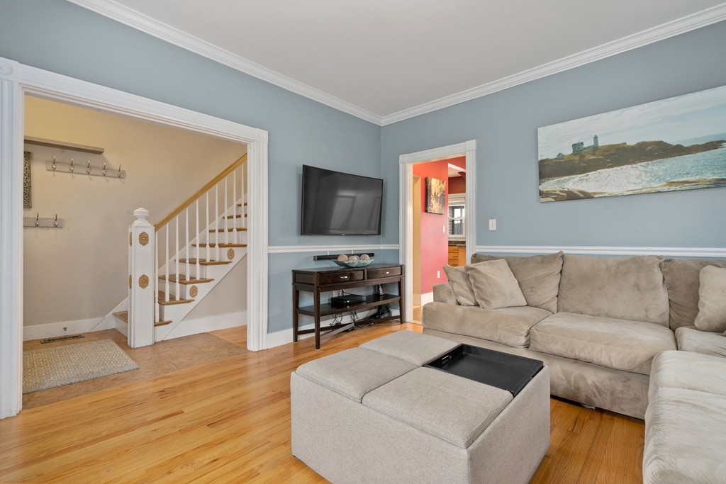 6 Porter Street, Unit 6 Woburn, MA 01801 - Photo 3 of 20 a living room with furniture and a flat screen tv