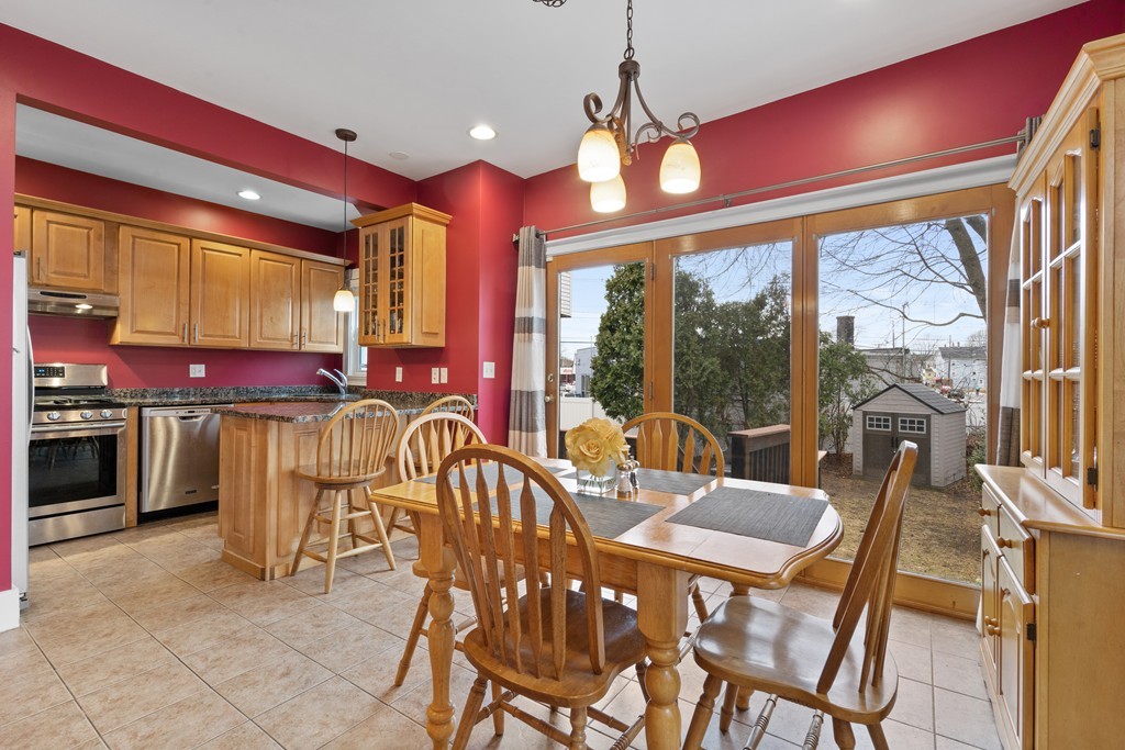 6 Porter Street, Unit 6 Woburn, MA 01801 - Photo 4 of 20 a view of a dining room with furniture large windows and chandelier