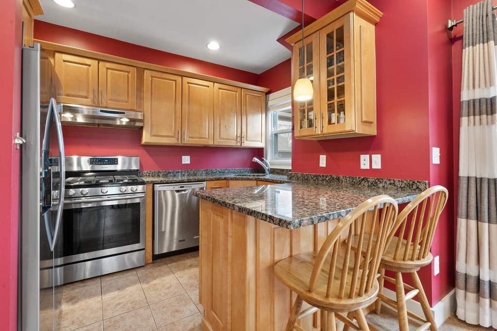 6 Porter Street, Unit 6 Woburn, MA 01801 - Photo 6 of 20 a kitchen with stainless steel appliances granite countertop a stove a sink and a refrigerator