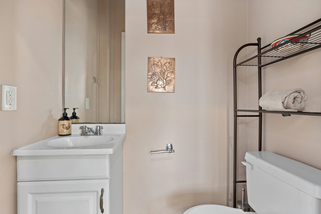 6 Porter Street, Unit 6 Woburn, MA 01801 - Photo 8 of 20 a bathroom with a sink mirror vanity and toilet
