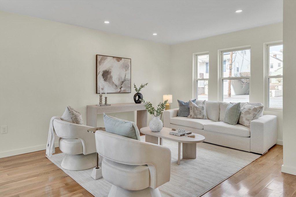 56 Riverview Street Dedham, MA 02026 - Photo 2 of 29 a living room with furniture and a large window