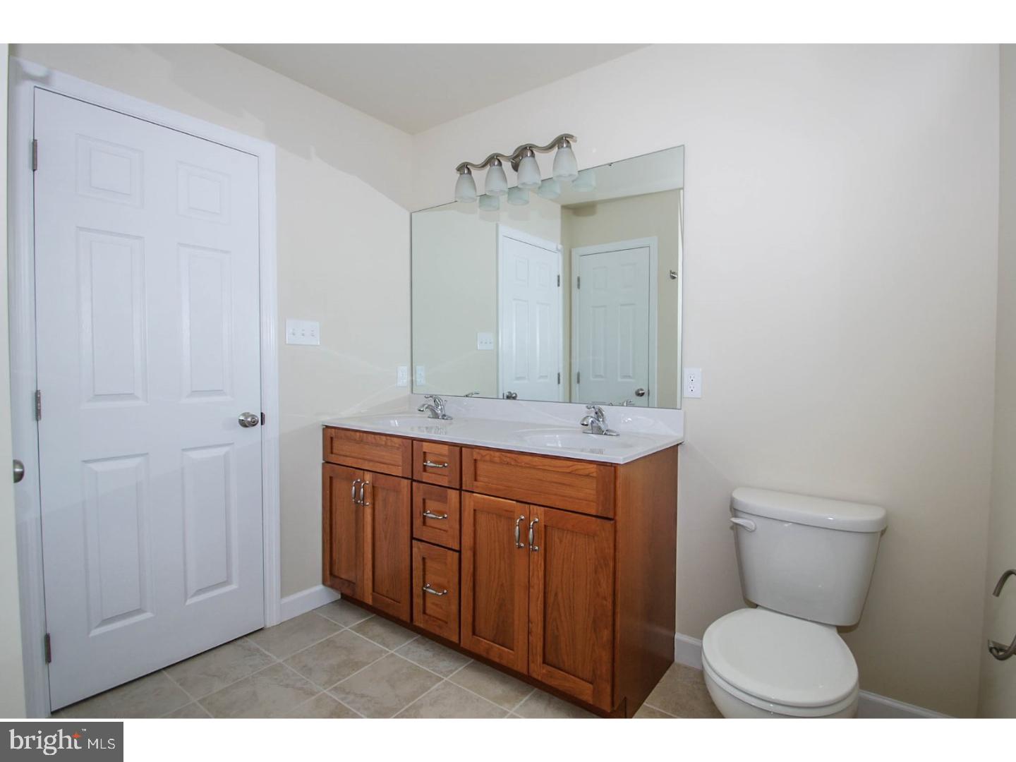 4520 Sefranka Road Temple, PA 19560 - Photo 14 of 23 a bathroom with a toilet sink and mirror