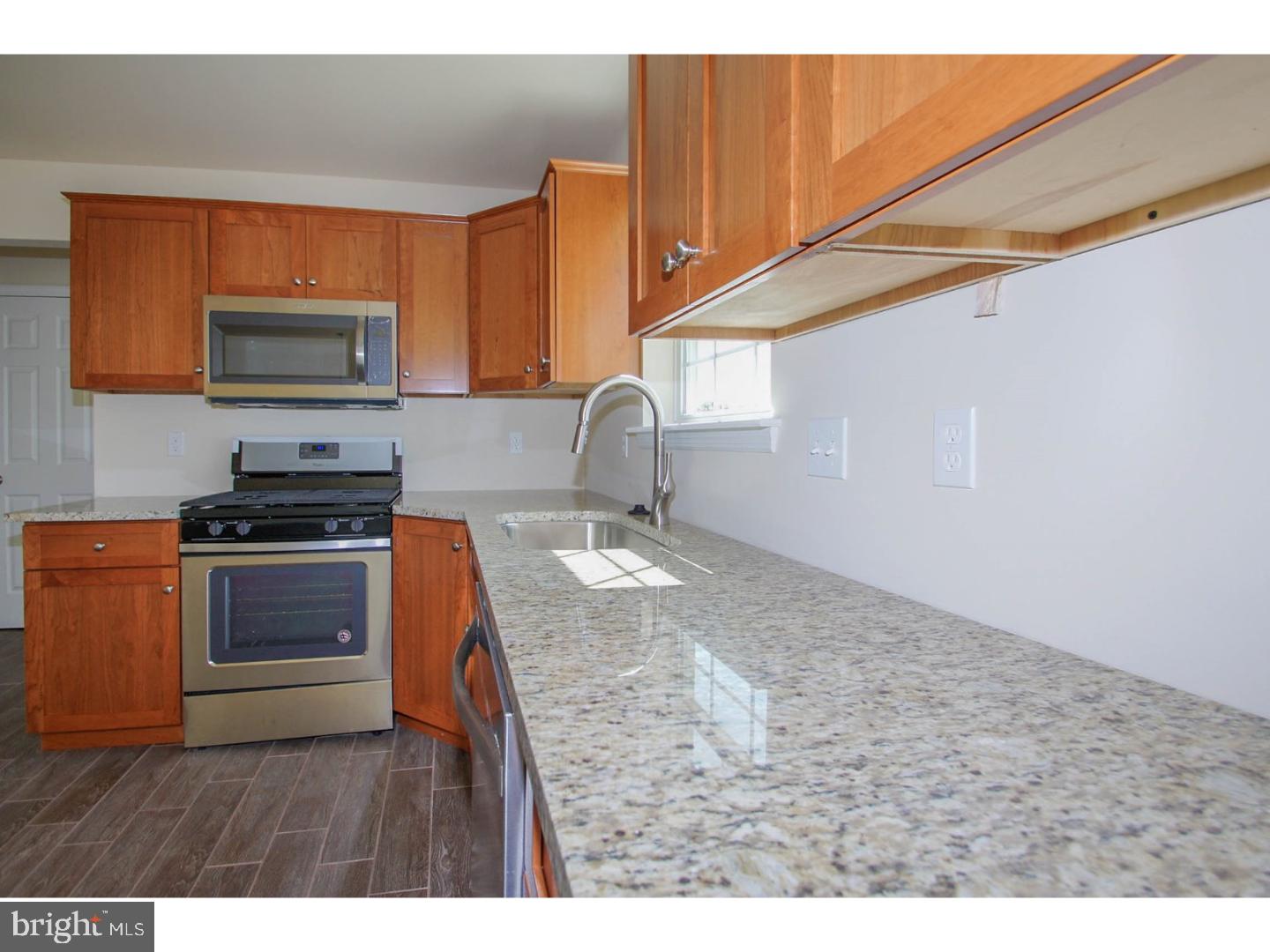 4520 Sefranka Road Temple, PA 19560 - Photo 9 of 23 a kitchen with granite countertop a stove and a sink