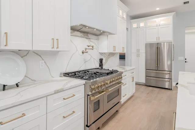 a kitchen with a stove and a refrigerator