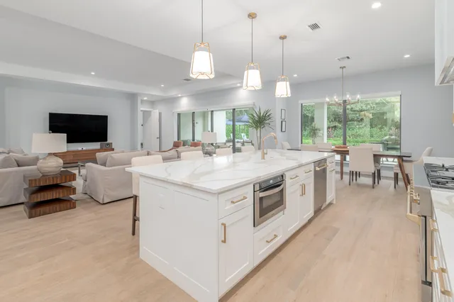 a large white kitchen with a large window