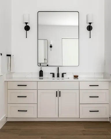 a bathroom with a sink vanity and mirror