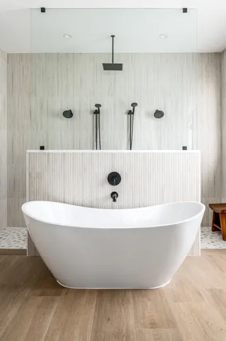 a white tub sitting next to a window