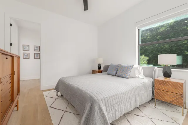 a bedroom with a bed and a night stand