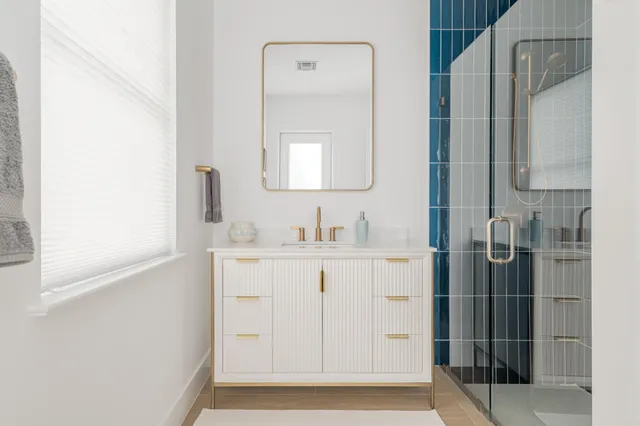 a bathroom with a sink a mirror and shower