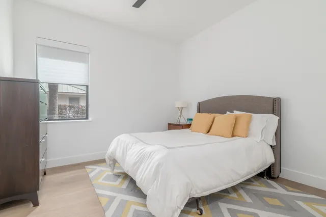 a bedroom with a bed and mirror