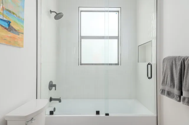 a bathroom with a bathtub and a shower