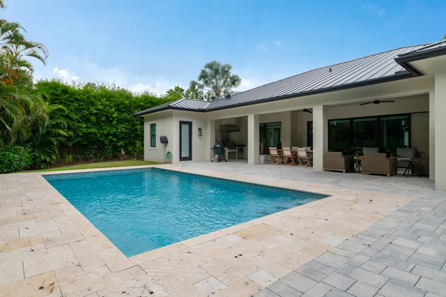 a view of a house with backyard porch and sitting area