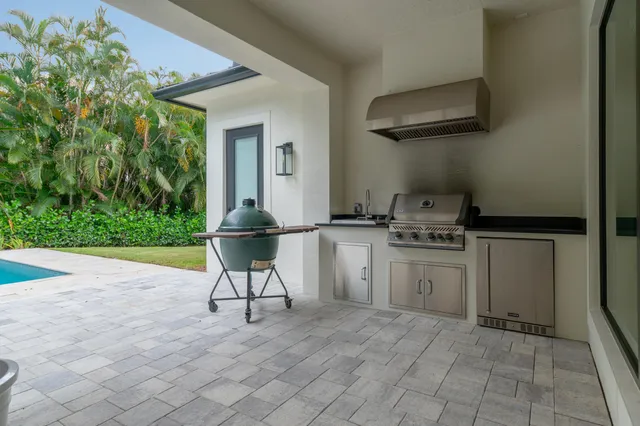 a living room with patio furniture and a garden