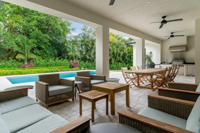 a view of a house with pool porch and chairs