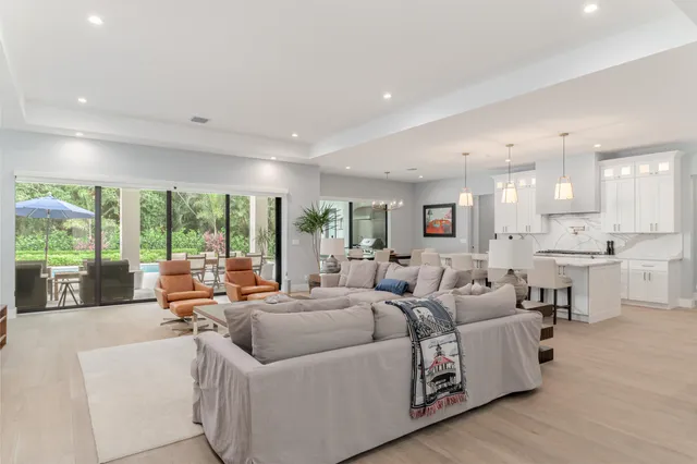 a living room with furniture and large windows